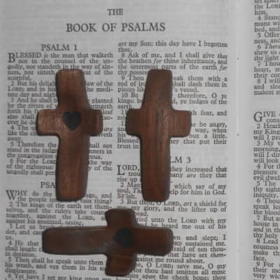 3 Cross My Heart Small Handheld Wooden Crosses Sitting On Holy Bible Front and Back